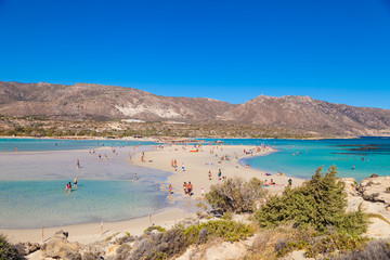 ELAFONISI, CRETE,  GREECE - AUGUST 14, 2018: People swimming and rest at Elafonisi beach. The heavenly wild beach with turquoise water.