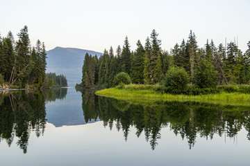 Fototapeta na wymiar Reflection on Water of Beautiful Northern River