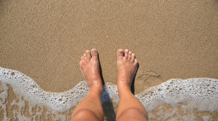 Feet on sandy beach