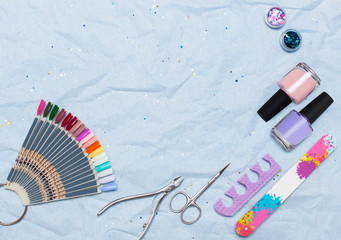 Nail work flat lay concept. Stylish trendy female manicure. top view on professional tools of the master of manicure and pedicure: varnishes, nail file, scissors with space for text