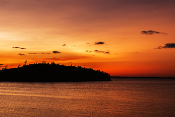 Fototapeta premium Sunset on lake Ladoga. On the horizon are visible the outlines of the Islands