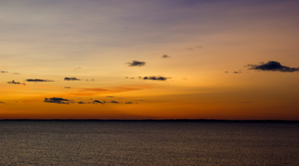 Lake with orange sunset cloudy sky