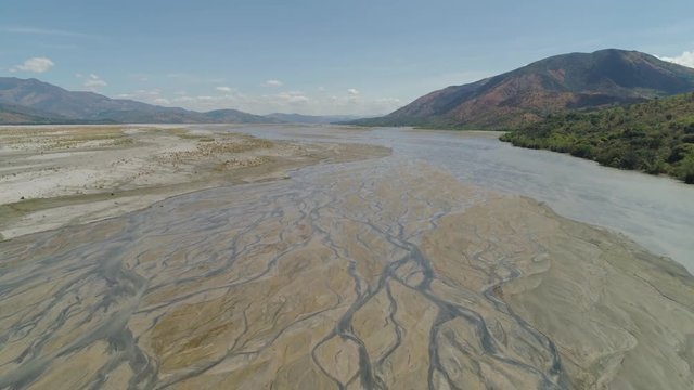 Parched river in mountain province Luzon, Philippines. Aerial view Drought in mountain valley, dry and shallow Bucao river.
