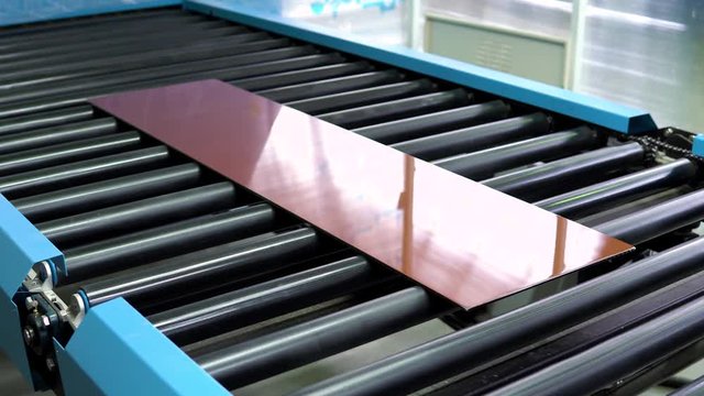the process of painting the glass in color. Conveyor belt for production a window pane. Industrial equipment.