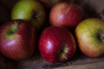 Fototapeta na wymiar Colourful shiny apples on the wooden fruit tray