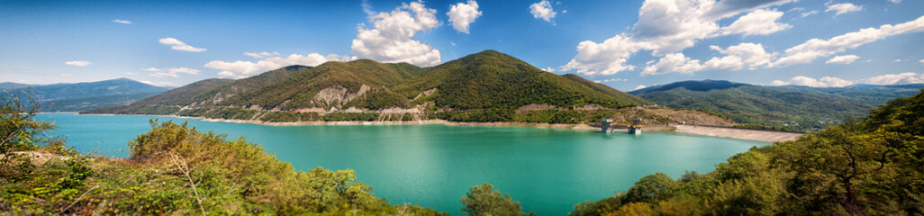 Panoramic view of the Jinvali Water Reservoir, beautiful mountains in the background. Georgia,...