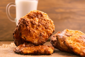 Delicious Breakfast - round homemade cookies on a linen napkin, a glass of milk.