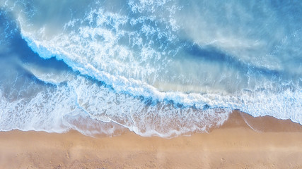 Beach and waves from top view. Aerial view of luxury resting at sunny day. Summer seascape from air. Top view from drone. Travel concept and idea