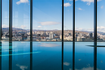 Contemporary interior with swimming pool and city view. Great water surface
