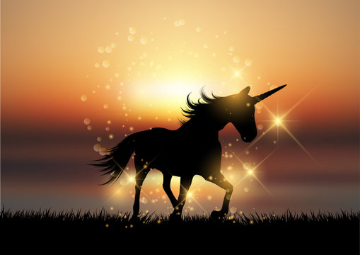 Fototapeta Silhouette of a unicorn in a sunset landscape