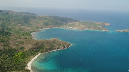 Fototapeta na wymiar Aerial view of seashore with beach, lagoons and coral reefs. Philippines, Luzon. Coast ocean with tropical beach, turquoise water. Tropical landscape in Asia.