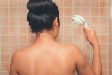 Portrait of beautiful woman is taking shower