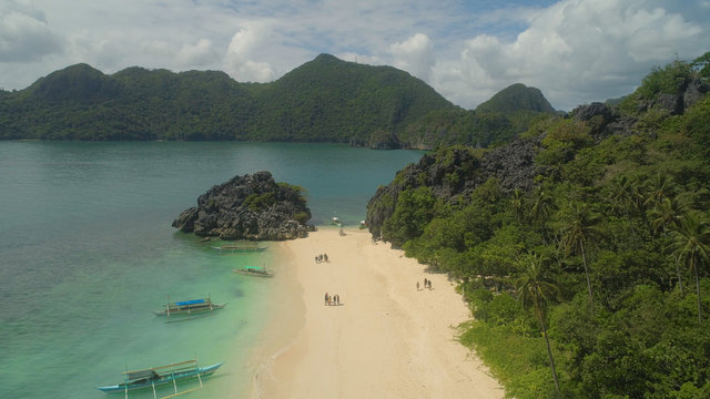 Aerial view with sand beach and turquoise water, Matukad island, Caramoan, Philippines. Landscape with sea, tropical beach.