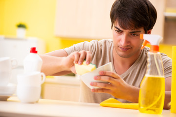 Man washing dishes at home
