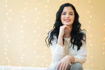 Happy young woman on a shiny lights background