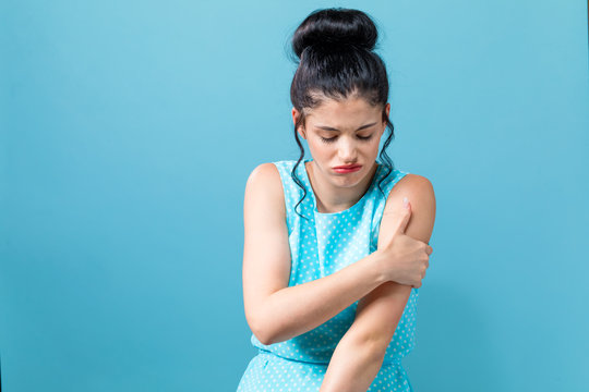 Young Woman Scratching Her Itchy Arm. Skin Problem.