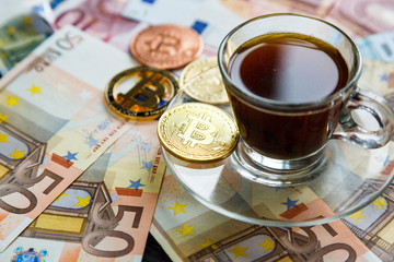 coins Bitcoin - crypto currency and traditional money. The choice of the modern world. Investments, cryptocurrency digital payment concept, various of bronze and golden bitcoins and cup of coffee.   