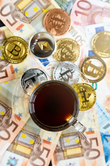 Obraz na płótnie Canvas coins Bitcoin - crypto currency and traditional money. The choice of the modern world. Investments, cryptocurrency digital payment concept, various of bronze and golden bitcoins and cup of coffee. 