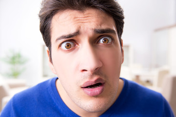 Fototapeta premium Young handsome man looking scared and surprised