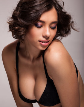 Photo of beautiful sensual woman in black bra, showing face expression