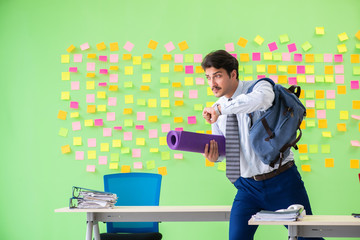 Man in the office with many conflicting priorities preparing go 