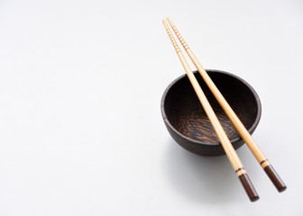 Top view of wood bowl and chopsticks on wood table background.Flat lay