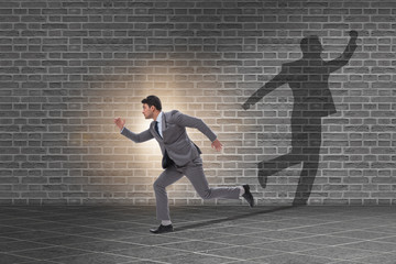 Businessman and his shadow in business concept