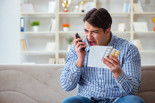 Young man sitting on the sofa with pills and prescription  - Powered by Adobe