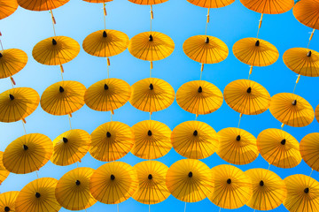 Fototapeta na wymiar Pattern Yellow umbrellas on blue sky.