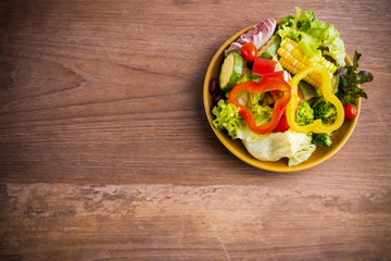 Fresh healthy salad on wood background. Weight loss. Slimming