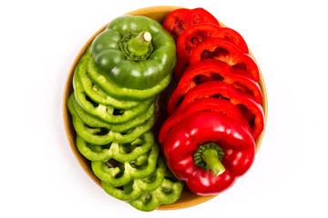 slices of red bell pepper and green bell pepper on isolated white background