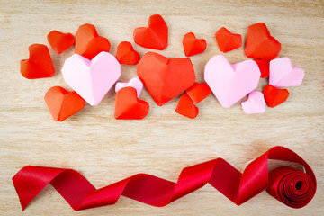 Red paper hearts Valentines day on Wooden table with copy space