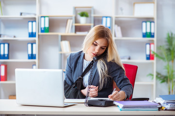 Injured female employee working in the office
