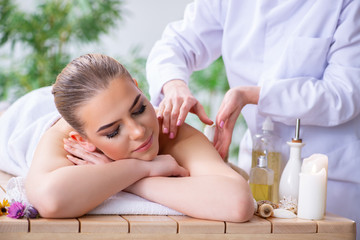 Fototapeta na wymiar Woman during massage session in spa