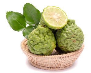 The kaffir lime leaves in the basket on a white background.