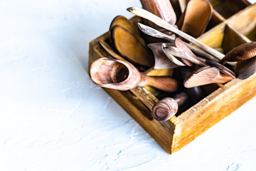Wooden box full of spoons