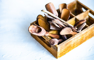 Wooden box full of spoons