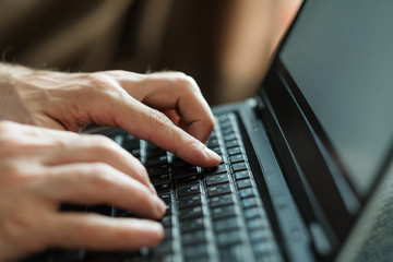 freelance work or remote job concept. man hands typing on laptop keyboard.