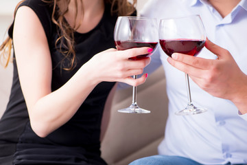 Young pair drinking wine in romantic concept