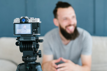 modern equipment for video shooting. man using camera on tripod for footage creation. helpful tools for blogging concept.