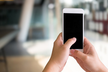 Mockup smartphone on hands with a blur background.