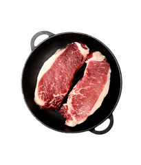fresh raw marble beef in a frying pan on a white background.Top view.