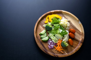 Top view fresh garden salad on wooden plate