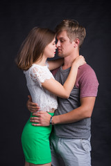 Passionate young people in love on black background