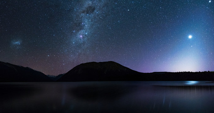 Panorama, Amanzing Starry night at Lake Rotoiti. Reflection of the Milky way and galaxy on the lake. Nelson Lake National Park, New Zealand. High ISO Photography.