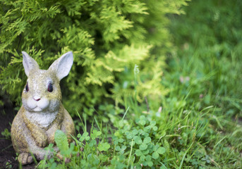 Artificial rabbit statue in the green garden area