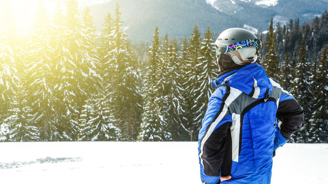 Young Handsome Man In Winter Sportswear Looking Away, Wearing Big Mirrored Ski Mask