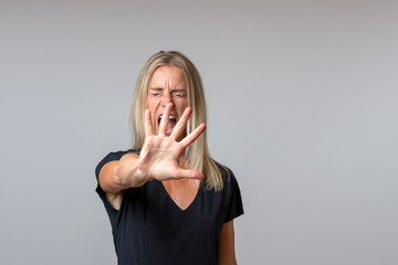 Imperious arrogant woman gesturing with her hand