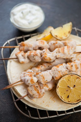 Closeup of greek souvlaki or skewers with chicken meat, vertical shot, selective focus