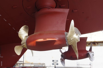 Double propellers on a massive supply vessel. Ship in a dry dock for repairs and annual survey.